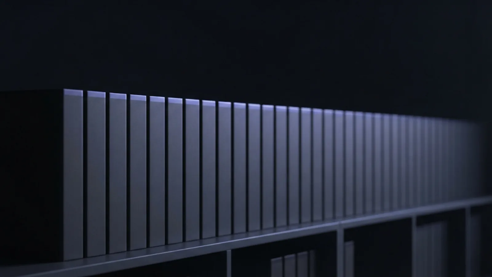A long row of matching grey document folders on a shelf, lit along their edges by a thin blue-violet light.